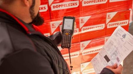 Logistikmitarbeiter von Kaufland überprüft mit einem MDE-Gerät die verladene Ware und die Warenbegleitpapiere.